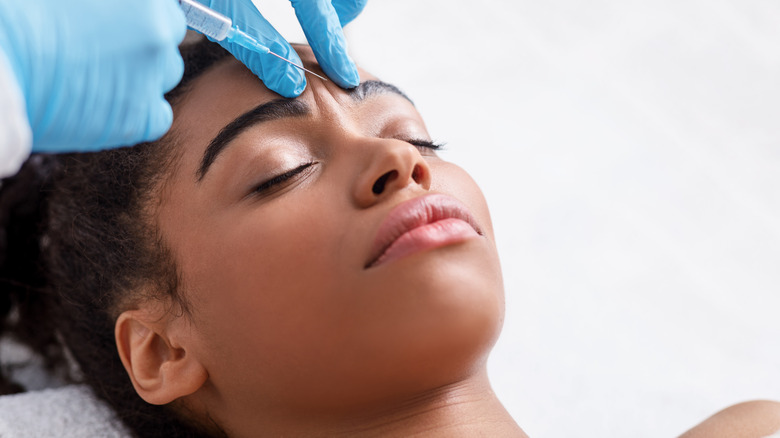 woman getting face injection