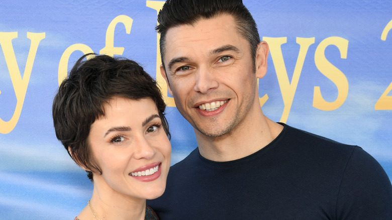 Linsey Godfrey and Paul Telfer pose for a photo. 