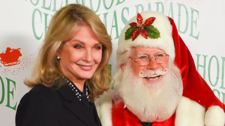 Deidre Hall poses with Santa Claus. 