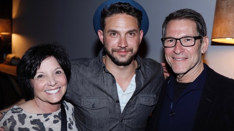 Brandon Barash and his parents smiling
