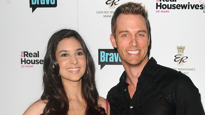 Camila Banus and Eric Martsolf pose on the red carpet.