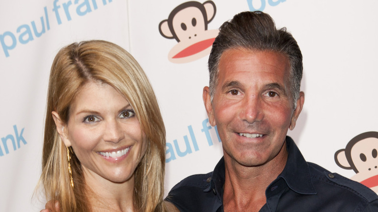 Lori Loughlin and Mossimo Giannulli smiling while posing together
