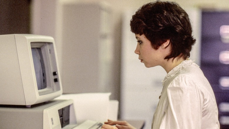 A woman typing into her IBM computer