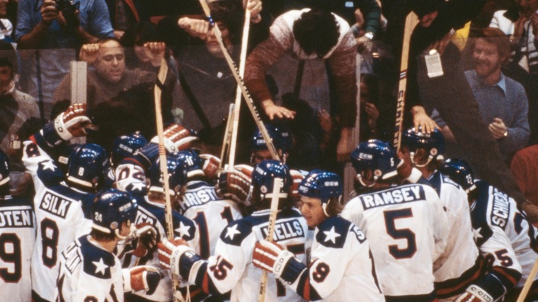 The US hockey team celebrates with fans after beating the Soviet Union at the 1980 Olympics