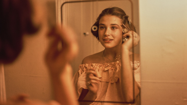 Demi Moore putting makeup on in mirror