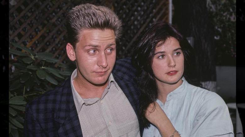 Emilio Estevez and Demi Moore looking to the side