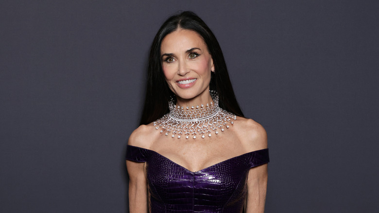 Demi Moore smiling in purple dress