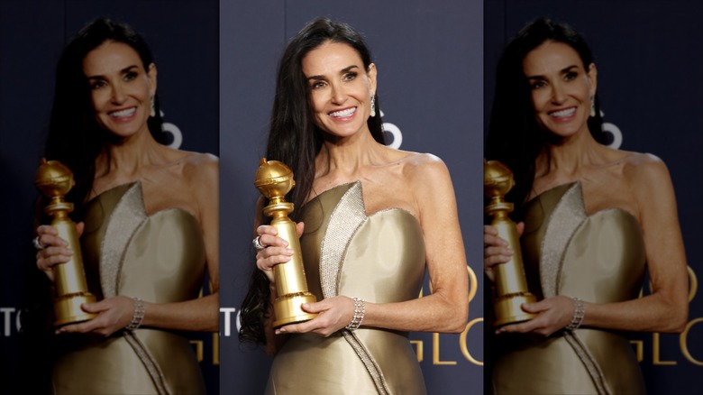 Demi Moore posing with her Golden Globe in 2025
