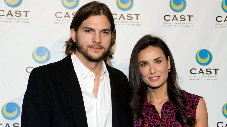 Demi Moore and Ashton Kutcher posing together at an event