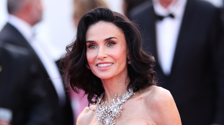 Demi Moore with short hair and a bejeweled necklace