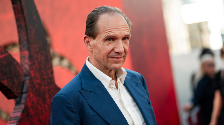 Ralph Fiennes in a blue blazer and white shirt