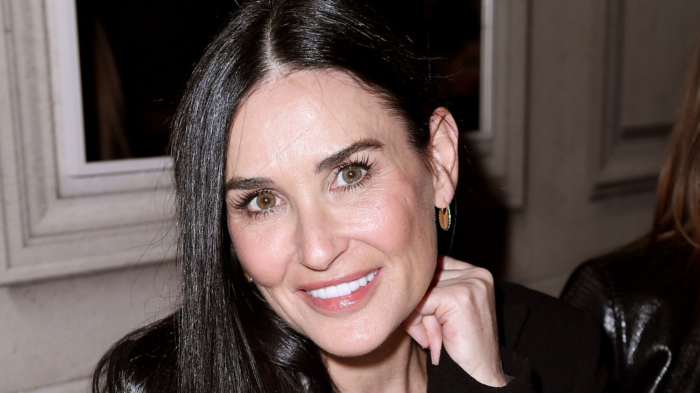 Demi Moore smiles wearing black