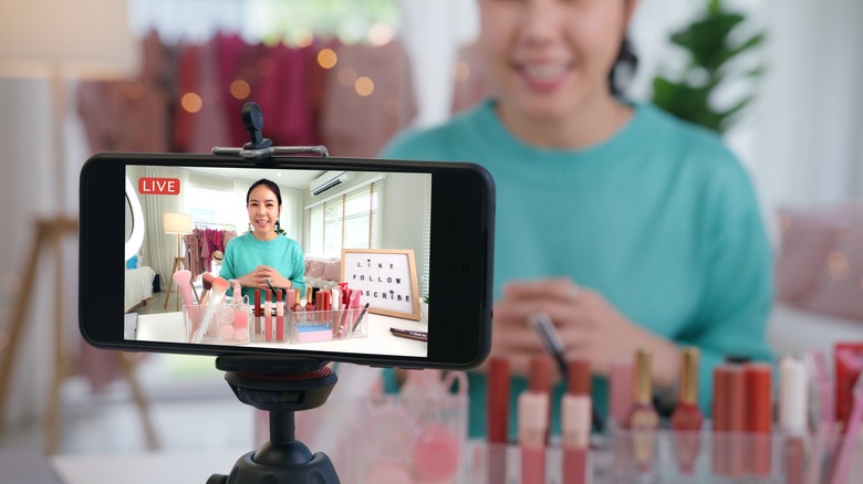 Young woman in front of her phone camera