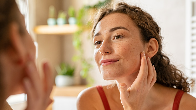 A woman checking her skin 