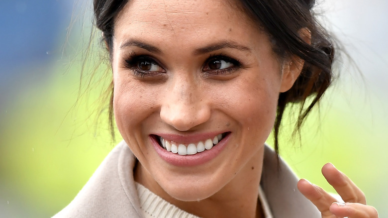 Meghan Markle waving coyly