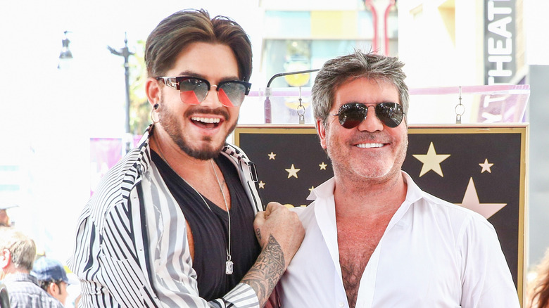 Adam Lambert posing with Simon Cowell