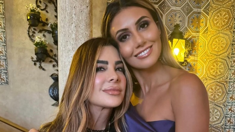 Alina Habba and Siggy Flicker leaning into each other for a photo