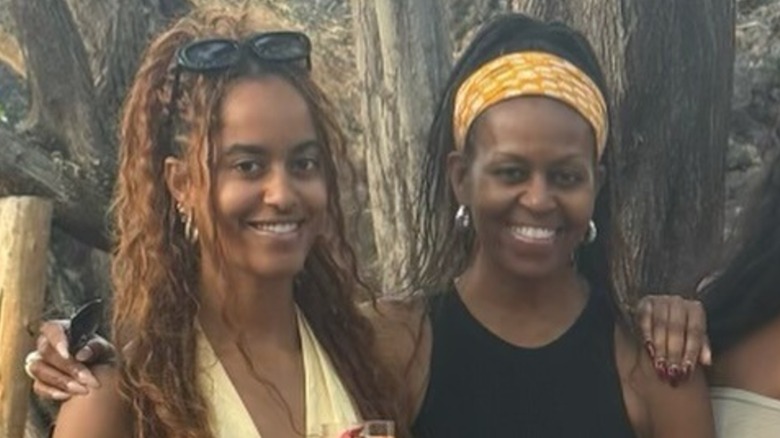 Malia and Michelle Obama posing for a photo, June 2025