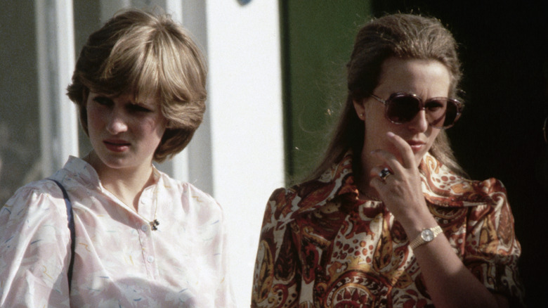 Princess Diana looking away from Princess Anne