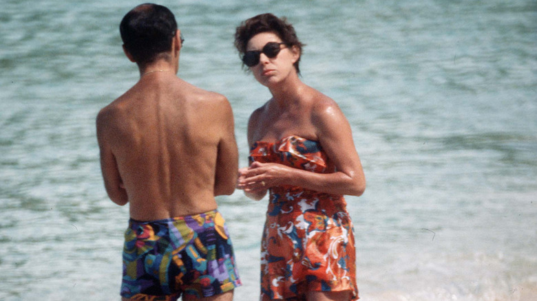 Princess Margaret in conversation with a man on the beach in Mustique