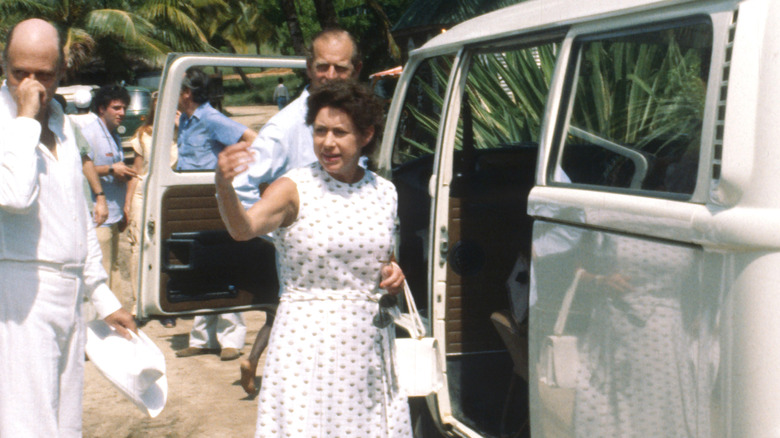 Princess Margaret gesturing with her hand outside a white van in Mustique