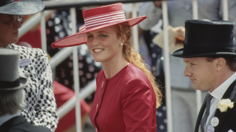 Sarah Ferguson smiling in red hat and dress in 1990s