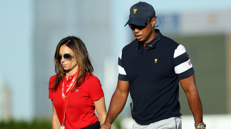 Tiger Woods and Erica Herman holding hands
