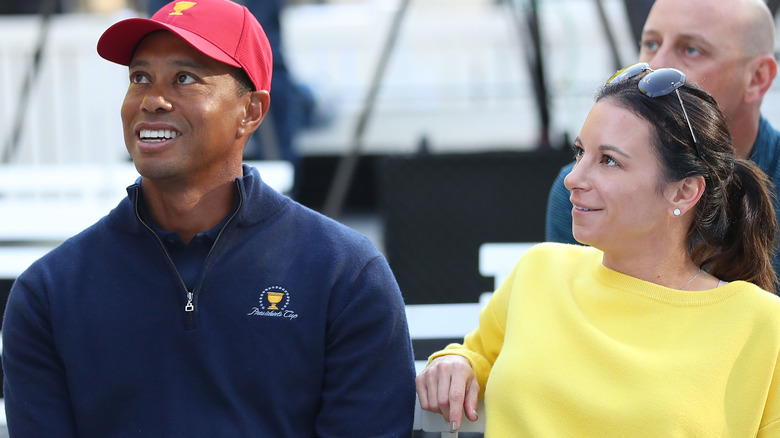 Tiger Woods and Erica Herman looking up
