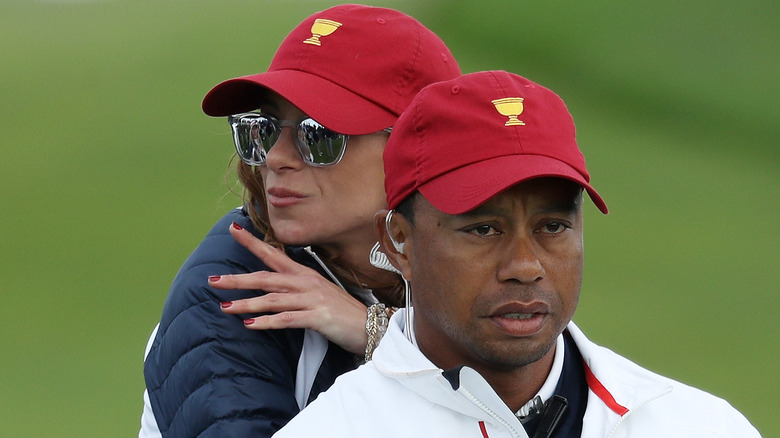 Tiger Woods and Erica Herman in red caps