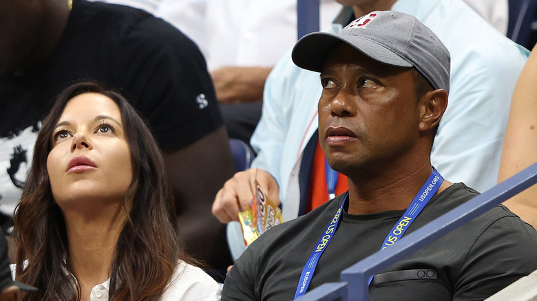 Tiger Woods and Erica Herman looking up