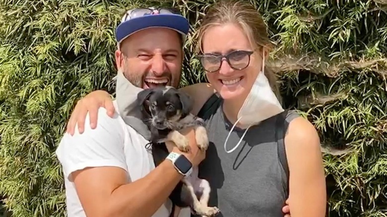 Gab Taraboulsy and Zoe Perry pose with a puppy