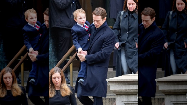 George Moran holding his child on stairs