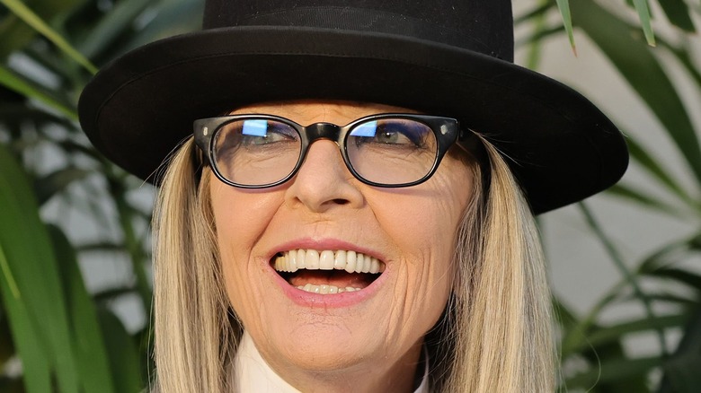 Diane Keaton smiling widely in top hat