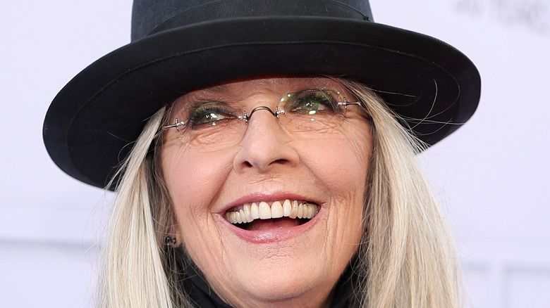 Diane Keaton laughing while wearing a hat as normal