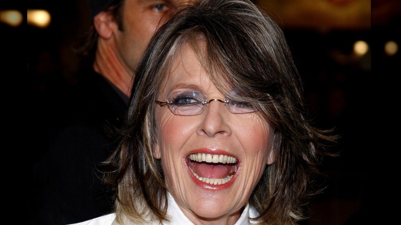 Diane Keaton smiling widely with her mouth open