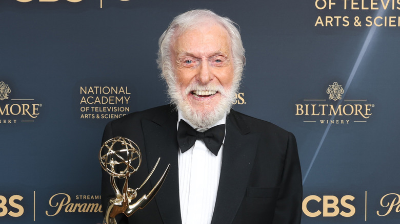 Dick Van Dyke smiling on red carpet holding an Emmy