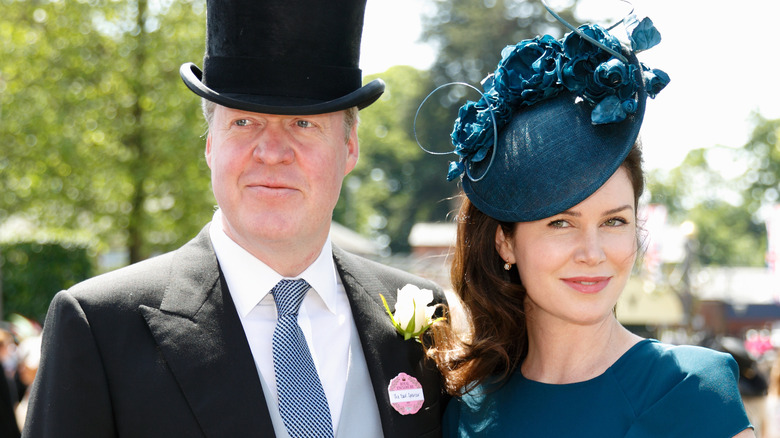 Charles Spencer and Karen Spencer posing for the camera in fancy hats