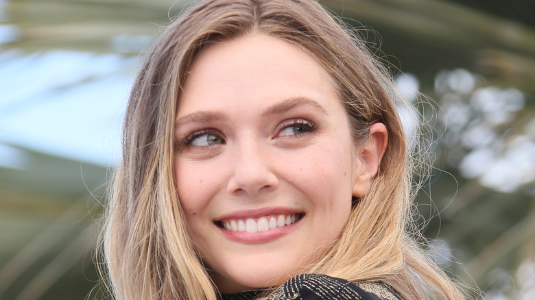 Elizabeth Olsen smiles at an event