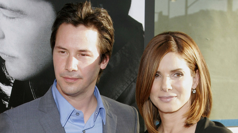 Keanu Reeves and Sandra Bullock posing at premiere