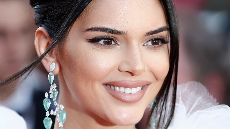 Kendall Jenner in white dress and diamond earrings