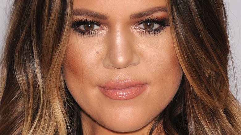 Khloé Kardashian smiles in a close up