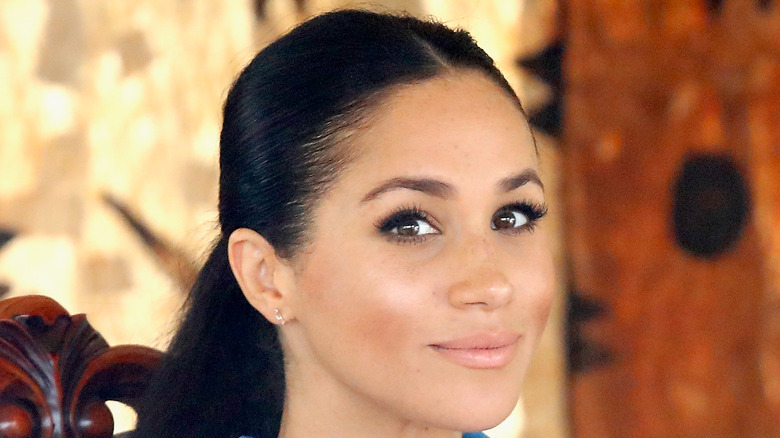 Meghan Markle looks at the camera