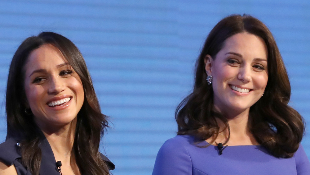 Meghan Markle and Kate Middleton pose onstage together