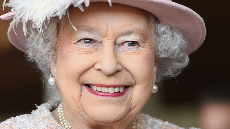 Queen Elizabeth in a pink hat