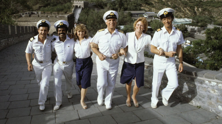 Stars of The Love Boat walk along the top of the Great Wall in Beijing. From left to right are: Fred Grandy, who plays the purser Burl "Gopher" Smith; Ted Lange, who plays the bartender Isaac Washington; Jill Whelan, who plays Captain Stubing's daughter Vicki; Gavin McLeod, who plays captain Merrill Stubing; Lauren Tewes, who plays cruise director Julie McCoy; and Bernie Kopell, who plays the ship's doctor Adam Bricker.