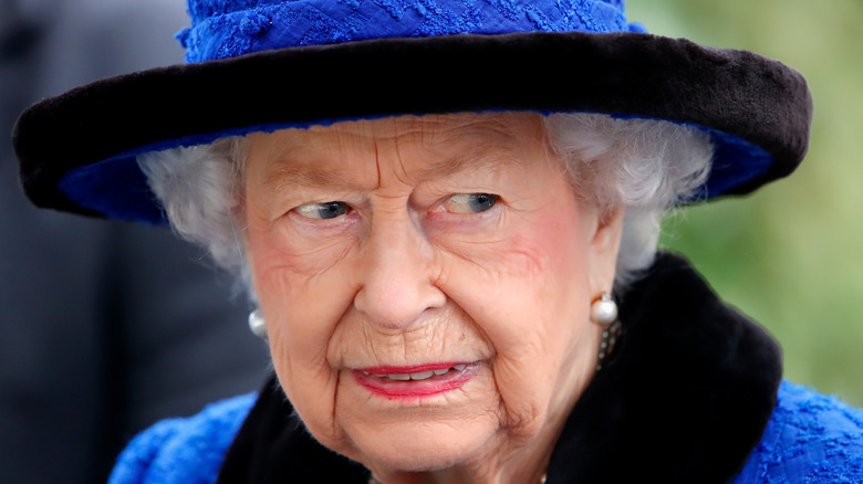 Queen Elizabeth II in blue hat