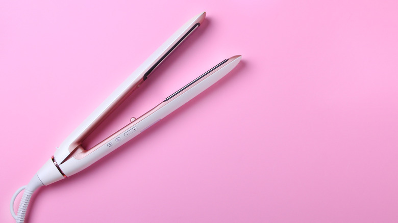 flat iron on pink background