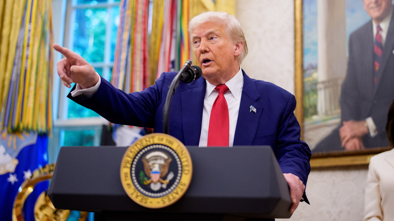 Donald Trump takes questions from reporters in the Oval Office