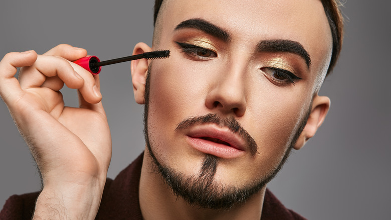 Man applying mascara