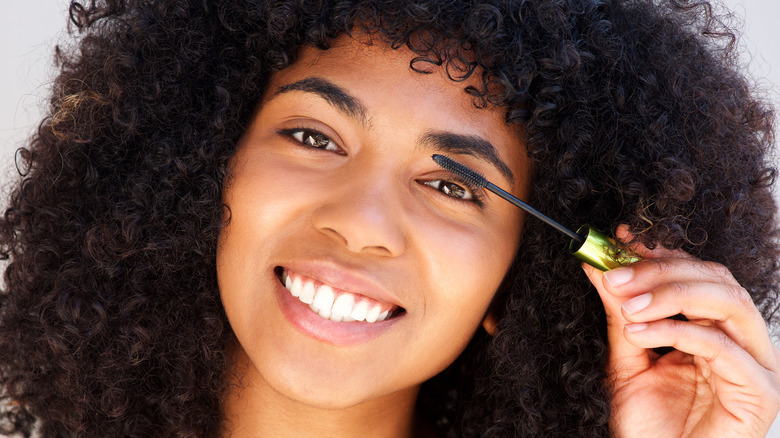 Man applying mascara